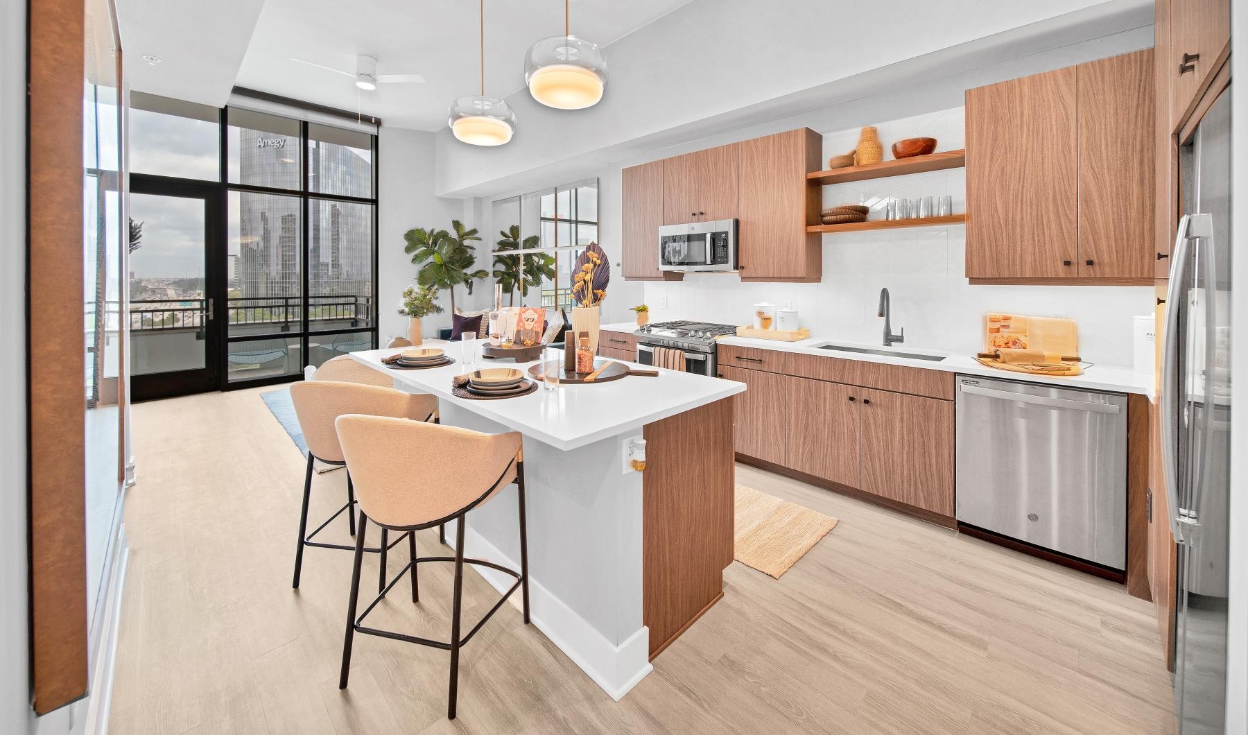 Close to the center of everything a kitchen with a bar and chairs