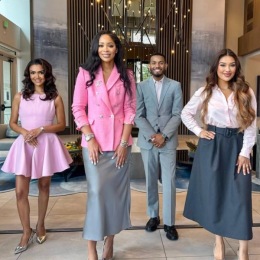 Leading the way a group of staff members standing in a lobby